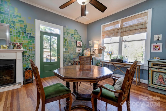 dining area with crown molding, hardwood / wood-style floors, and ceiling fan