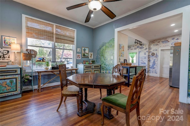 dining space featuring hardwood / wood-style flooring, ceiling fan, and crown molding