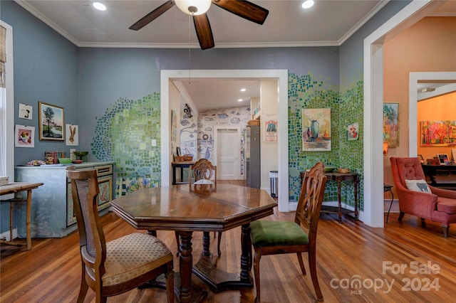 dining area with lofted ceiling, ceiling fan, wood-type flooring, and crown molding