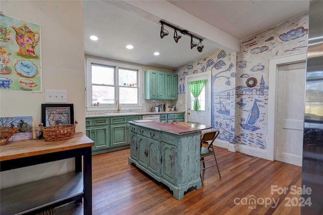 kitchen with a kitchen breakfast bar, green cabinets, wood-type flooring, and wood counters