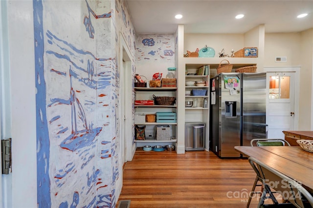 kitchen featuring stainless steel fridge with ice dispenser and wood-type flooring