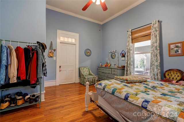 bedroom featuring ceiling fan, ornamental molding, and light hardwood / wood-style flooring