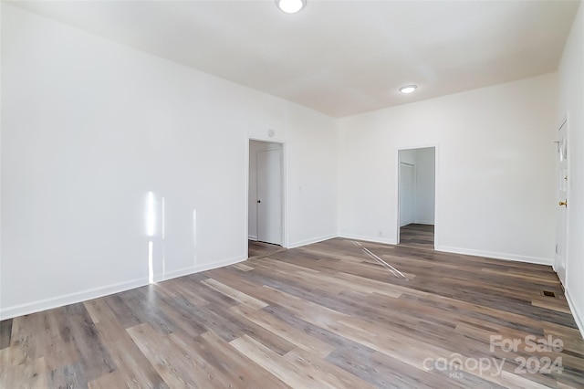 empty room with hardwood / wood-style floors