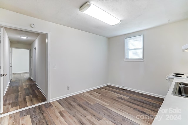 empty room featuring dark hardwood / wood-style flooring and sink