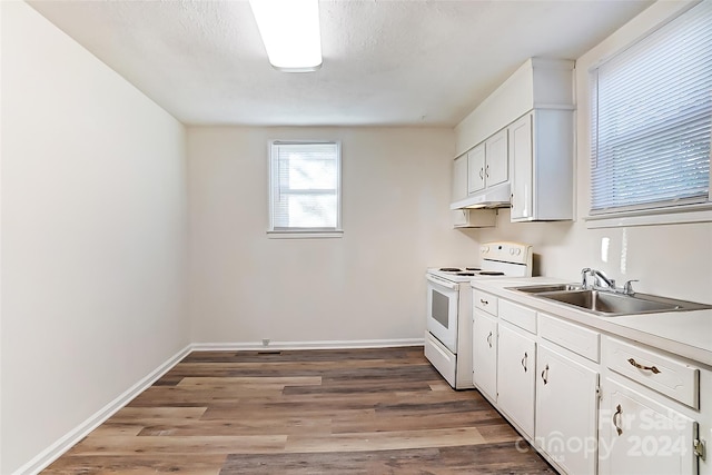 kitchen with electric stove, sink, white cabinets, and hardwood / wood-style floors