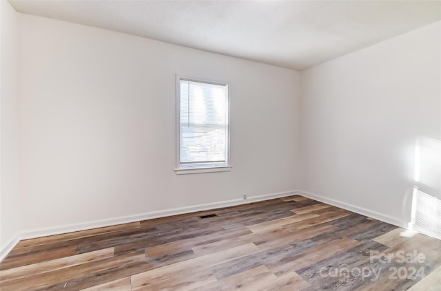 spare room with hardwood / wood-style floors