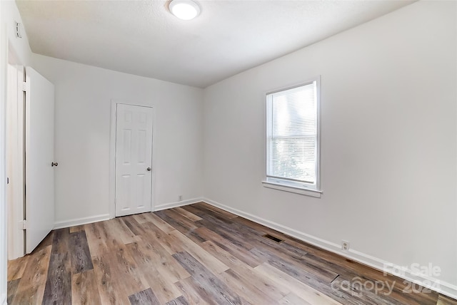 empty room with light hardwood / wood-style flooring