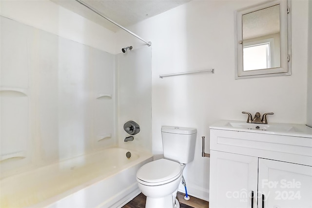 full bathroom featuring hardwood / wood-style floors, vanity,  shower combination, and toilet