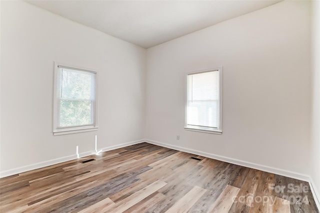 spare room with light hardwood / wood-style flooring