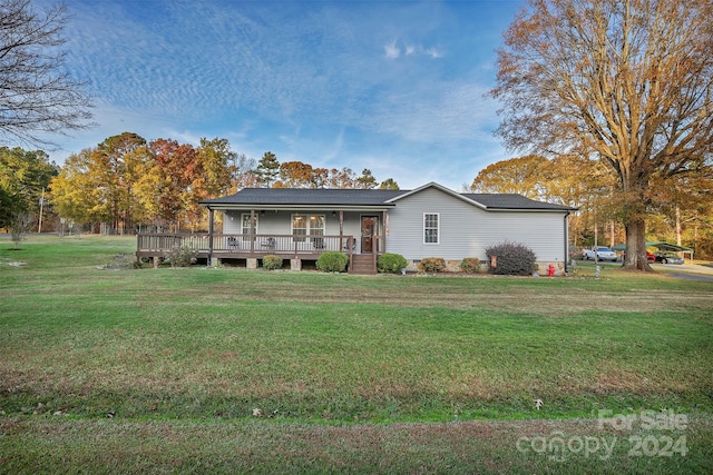 view of front facade with a front lawn and covered porch