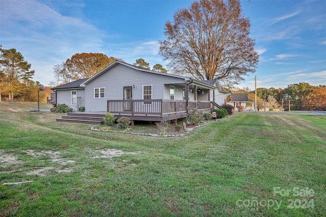 back of house with a yard and a wooden deck