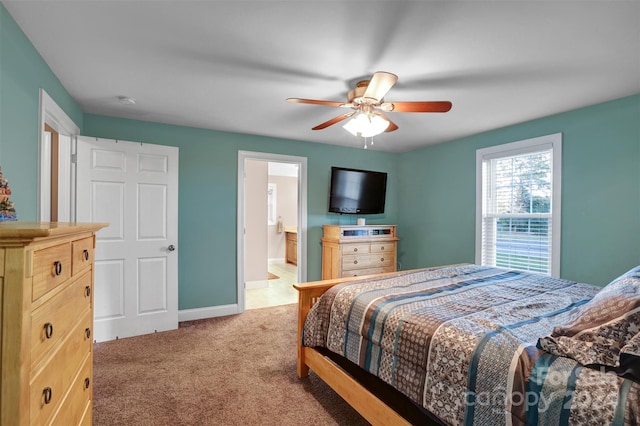 bedroom with carpet flooring, ensuite bath, and ceiling fan