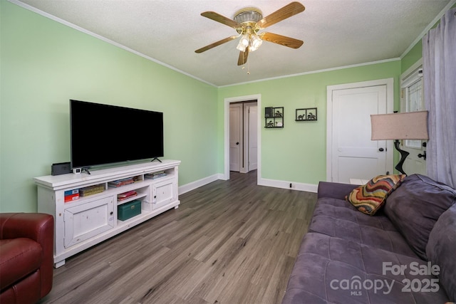 living room with crown molding, ceiling fan, hardwood / wood-style floors, and a textured ceiling