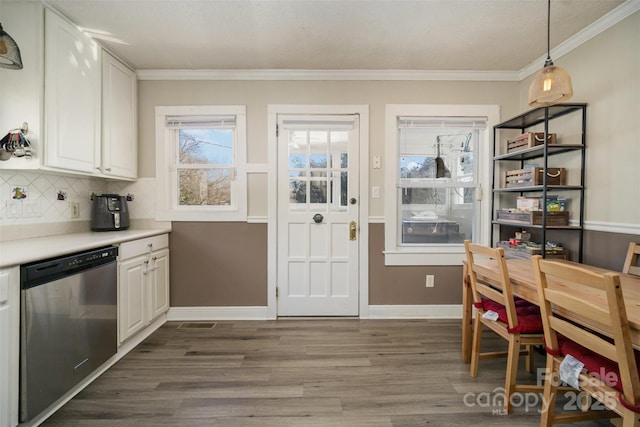 kitchen featuring tasteful backsplash, dishwasher, white cabinets, hanging light fixtures, and dark wood-type flooring