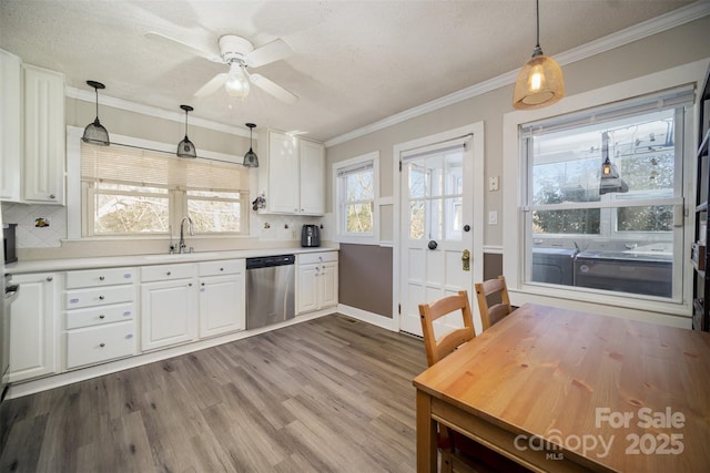 kitchen with white cabinetry, hanging light fixtures, wood-type flooring, and stainless steel dishwasher