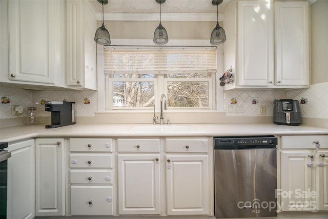 kitchen featuring sink, dishwasher, white cabinets, pendant lighting, and backsplash