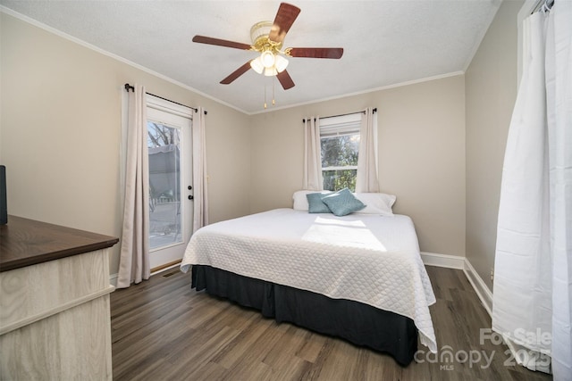 bedroom with dark wood-type flooring, ceiling fan, ornamental molding, and a textured ceiling