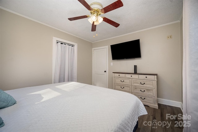 bedroom featuring dark hardwood / wood-style flooring, ceiling fan, crown molding, and a textured ceiling