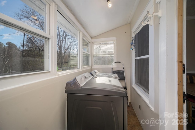 clothes washing area featuring separate washer and dryer