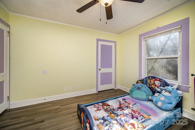 bedroom featuring dark hardwood / wood-style flooring, a textured ceiling, ornamental molding, and ceiling fan