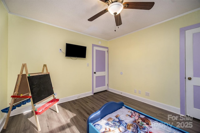 bedroom with ceiling fan, ornamental molding, and dark hardwood / wood-style flooring