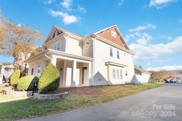 view of side of home featuring a porch