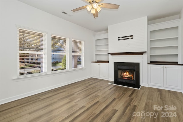 unfurnished living room featuring wood-type flooring and ceiling fan