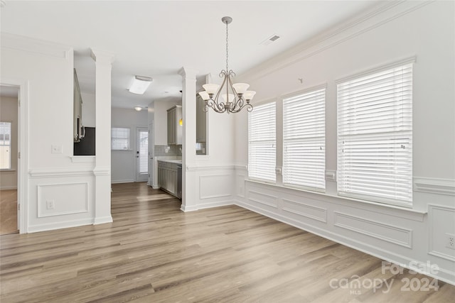 unfurnished dining area with light wood-type flooring and a wealth of natural light