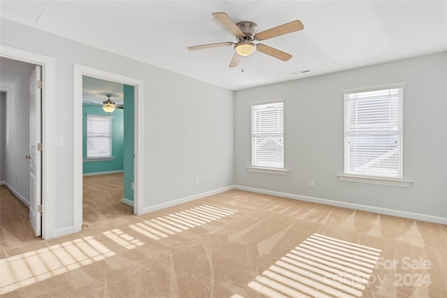 carpeted empty room with ceiling fan