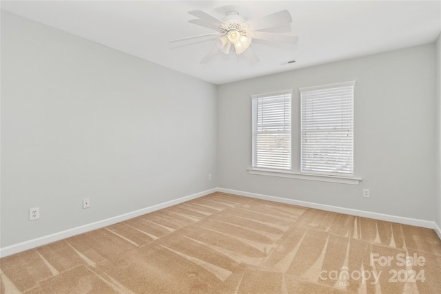 empty room featuring carpet flooring and ceiling fan