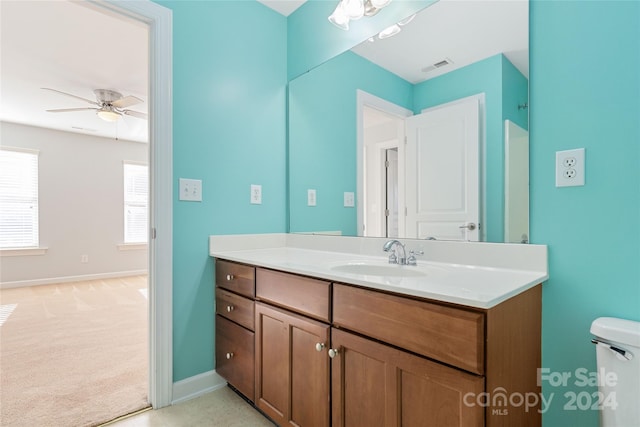 bathroom featuring ceiling fan, toilet, and vanity