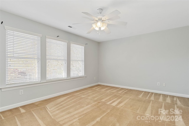 carpeted empty room featuring ceiling fan