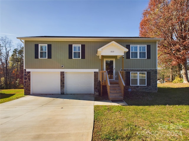 split foyer home with a front yard and a garage