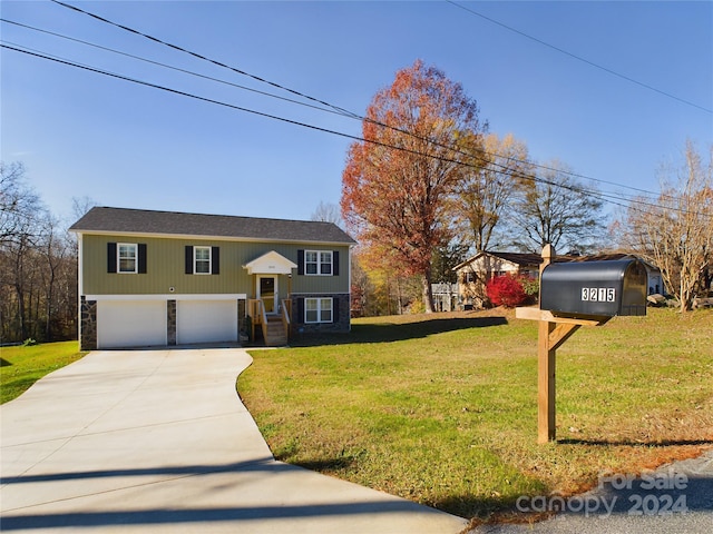 raised ranch with a garage and a front lawn