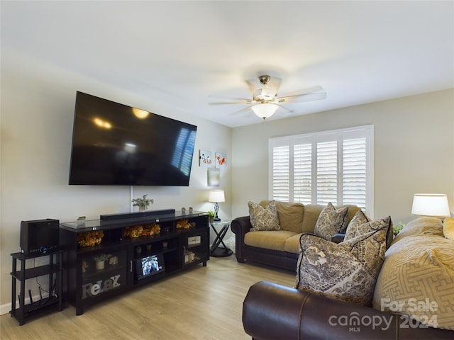 living room with ceiling fan and light hardwood / wood-style flooring