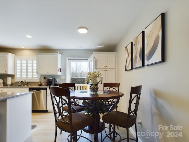 dining area featuring sink and light hardwood / wood-style flooring