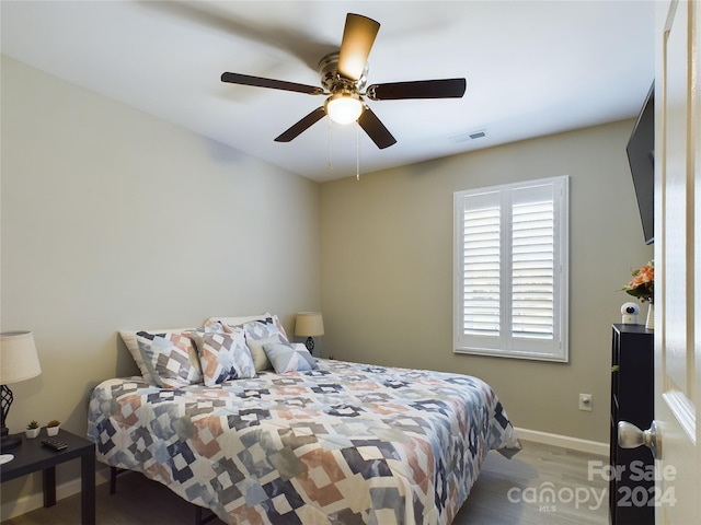 bedroom with ceiling fan and wood-type flooring