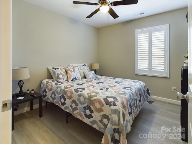 bedroom with light hardwood / wood-style floors and ceiling fan