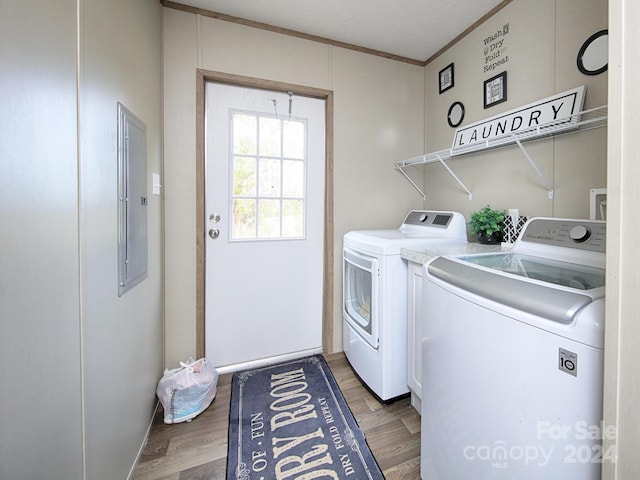 washroom featuring independent washer and dryer, hardwood / wood-style flooring, and ornamental molding