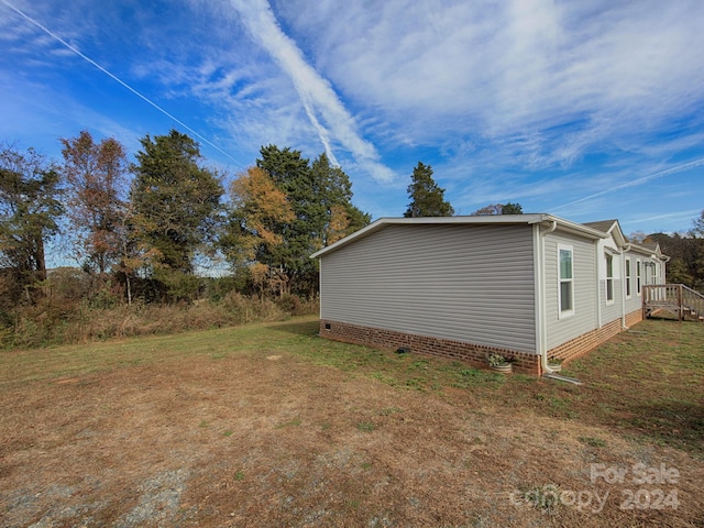 view of side of home with a yard