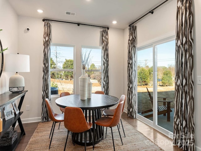 dining area featuring a wealth of natural light and dark hardwood / wood-style floors