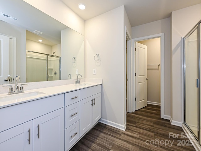 bathroom featuring vanity, an enclosed shower, and hardwood / wood-style flooring