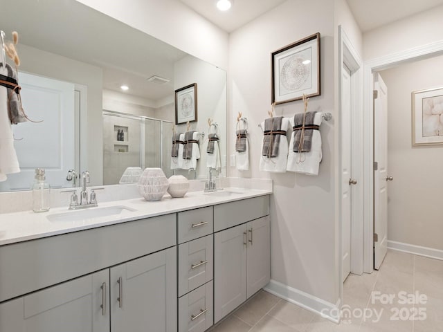 bathroom featuring tile patterned flooring, vanity, and a shower with shower door