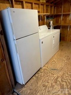 washroom with washer / clothes dryer and wood walls