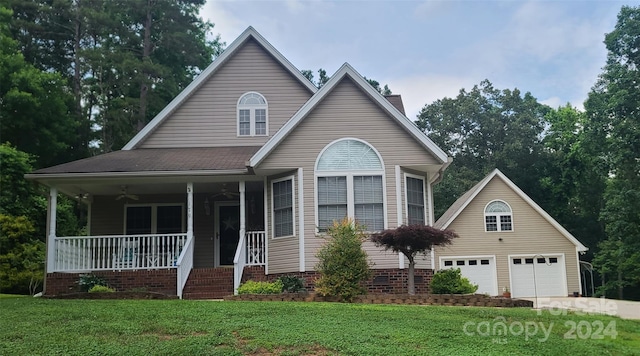 view of front facade with a garage, covered porch, and a front lawn