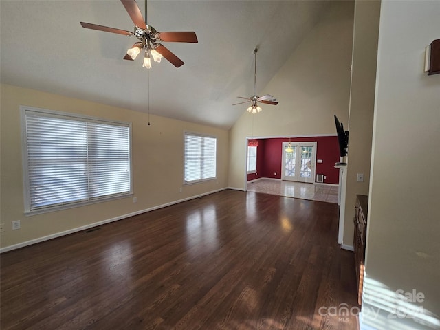 unfurnished living room with ceiling fan, dark hardwood / wood-style flooring, and high vaulted ceiling