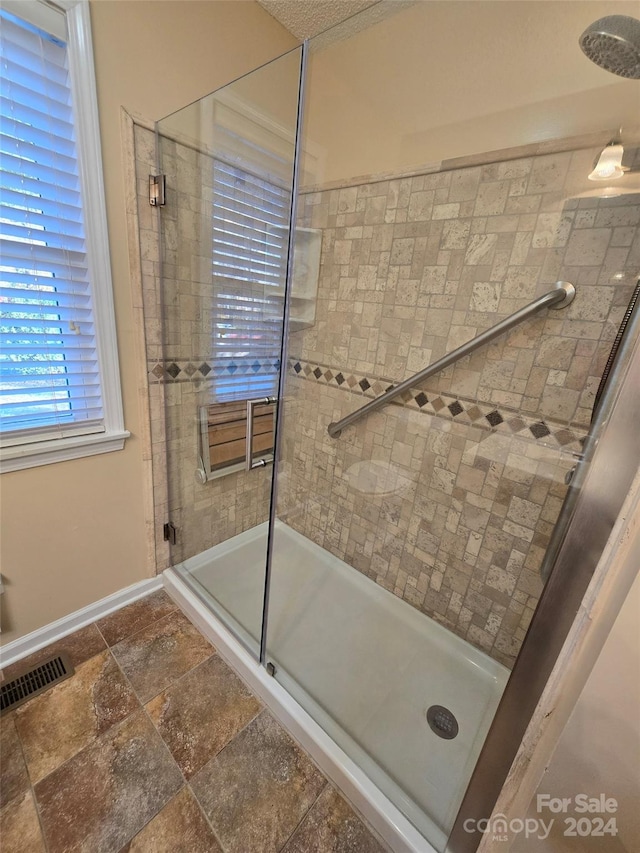 bathroom with a shower with door