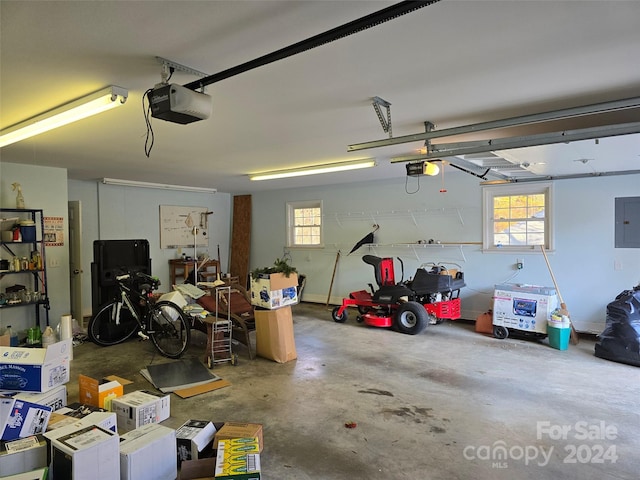 garage with electric panel and a garage door opener