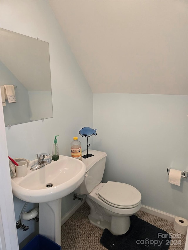 bathroom featuring toilet and lofted ceiling