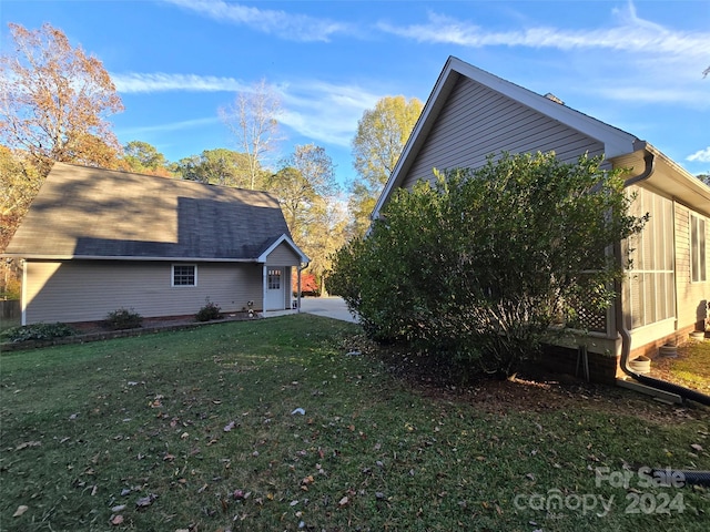 view of side of home featuring a yard